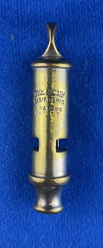 acme Model 048 small tubular whistle close-up showing stamped top cap and mouthpiece detail